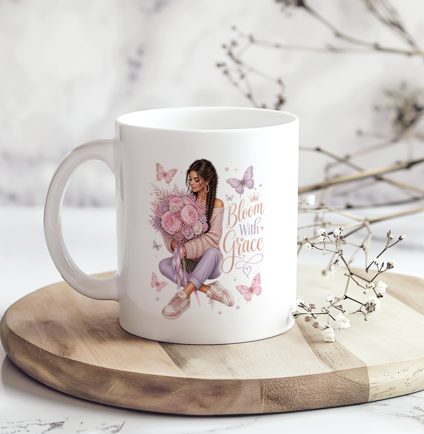 White ceramic coffee mug featuring a woman holding pink flowers with butterflies and the inspirational phrase "Bloom With Grace," a beautiful Christian floral coffee mug gift.