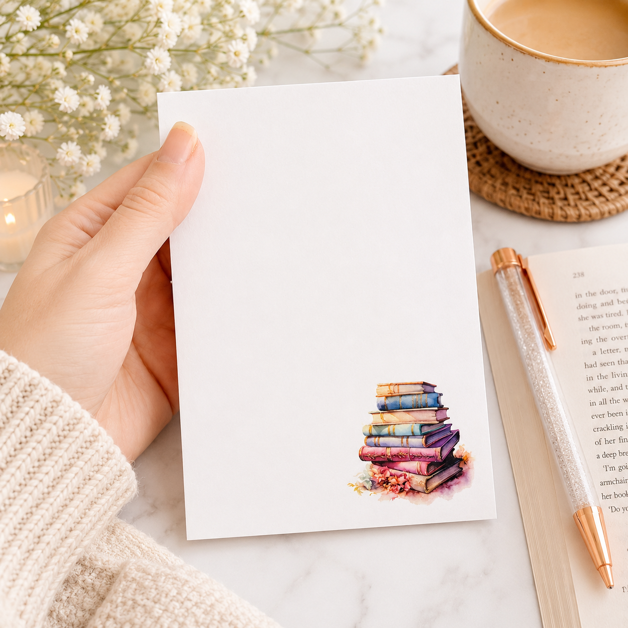 Book lover notepad featuring a watercolor stack of pastel vintage books in the corner with a clean writing area for notes, lists, and reminders.