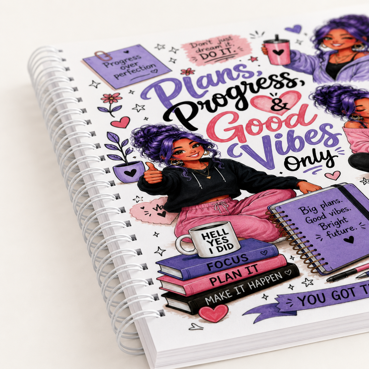 Spiral-bound Plans Progress and Good Vibes journal featuring purple-haired motivational artwork, productivity themes, and ADHD-friendly planning pages.