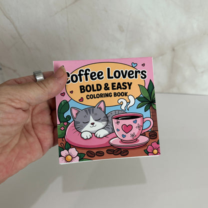Coffee Lovers Bold and Easy Mini Coloring Book featuring cute sleeping kitten beside a pink coffee cup with cozy café themed illustrations.