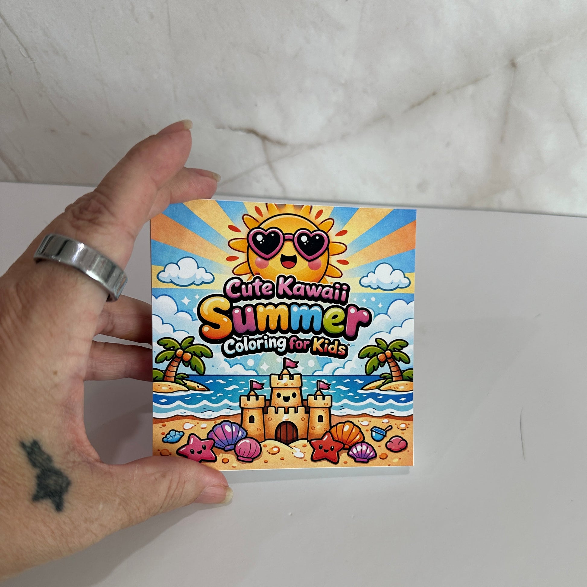 Cute kawaii summer mini coloring book featuring smiling sunshine, sandcastle, palm trees and beach illustrations for kids.