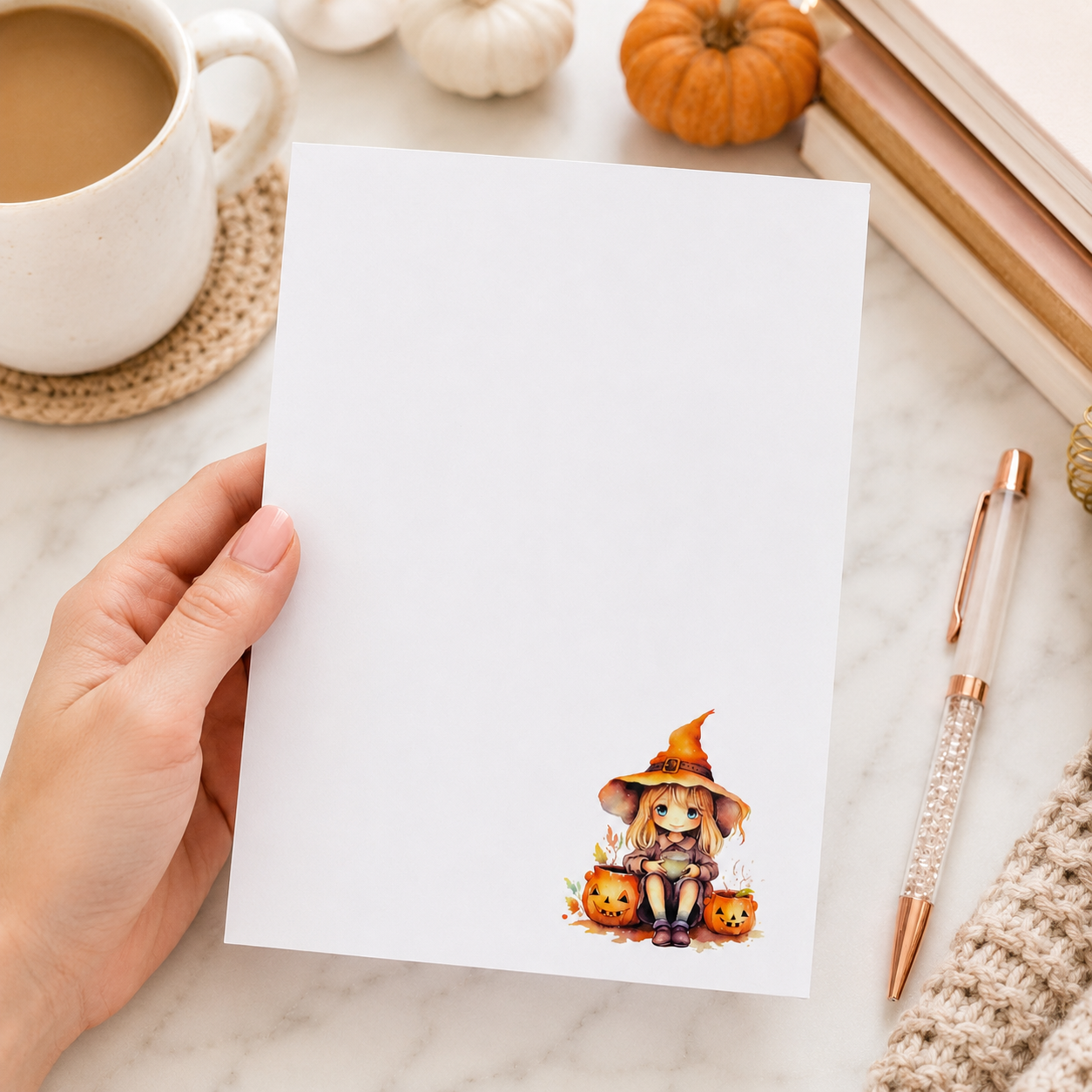 Halloween witch notepad featuring a cute witch sitting beside pumpkins on a white memo pad, autumn stationery gift for fall desk organization.