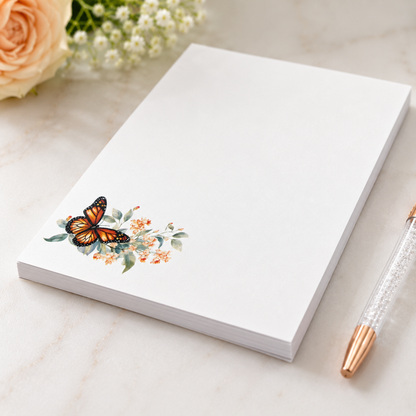 White butterfly floral notepad featuring a monarch butterfly with soft watercolor flowers in the corner and a large blank writing area.