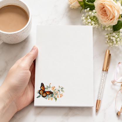 White butterfly floral notepad featuring a monarch butterfly with soft watercolor flowers in the corner and a large blank writing area.