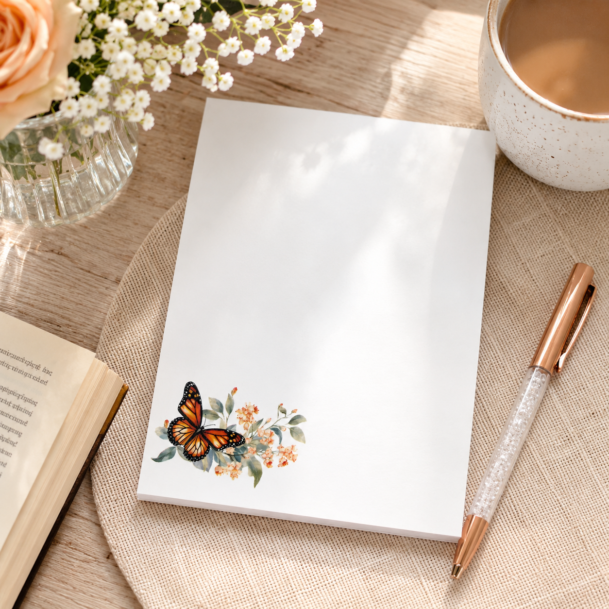 White butterfly floral notepad featuring a monarch butterfly with soft watercolor flowers in the corner and a large blank writing area.
