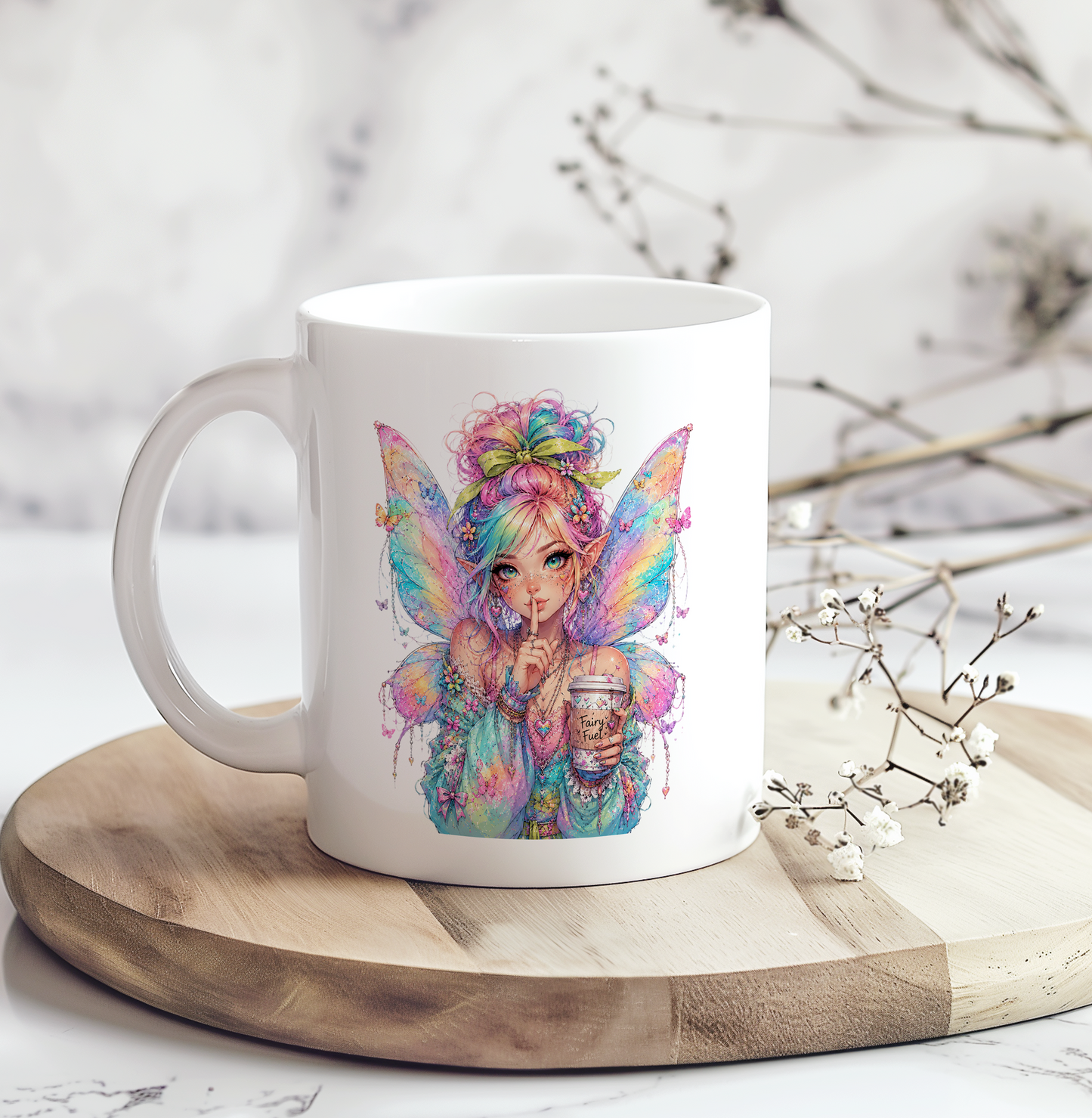White ceramic coffee mug featuring a colorful pastel fairy holding a "Fairy Fuel" coffee cup with iridescent wings, making it a whimsical fantasy coffee mug for fairy lovers and magical gift ideas.