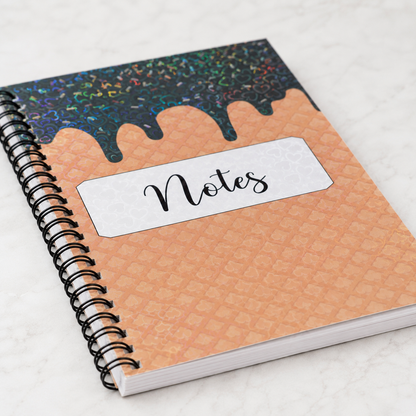 Ice cream Cone Waffle Pattern Heart shaped holographic spiral notebook with lined pages, and Notes label displayed in a bright feminine workspace setting. 