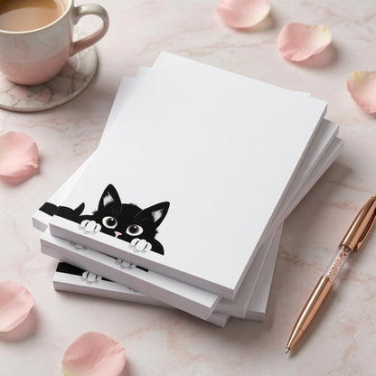 White notepad featuring a cute black kitten peeking from the bottom corner with plenty of blank writing space for notes, lists, and reminders.