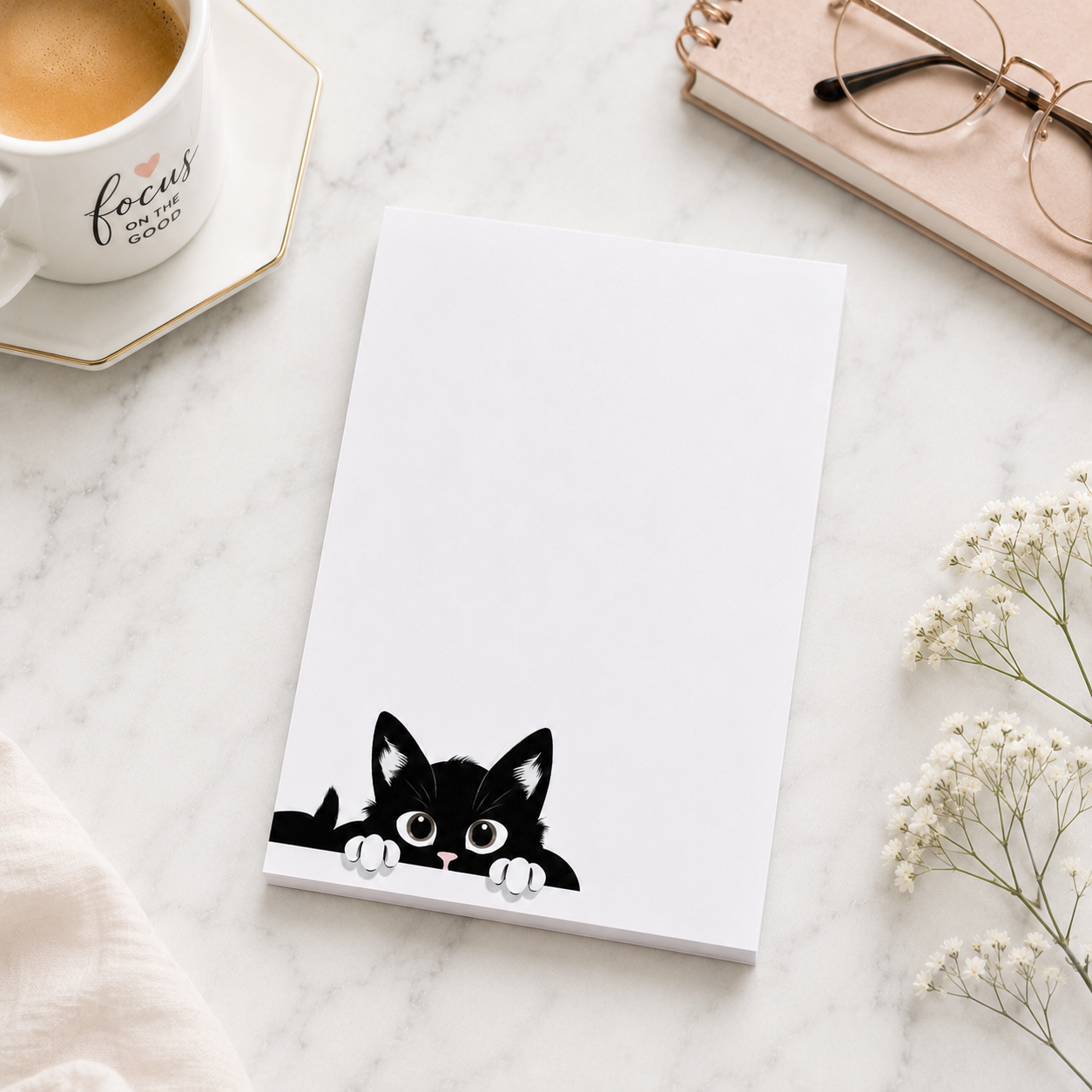 White notepad featuring a cute black kitten peeking from the bottom corner with plenty of blank writing space for notes, lists, and reminders.