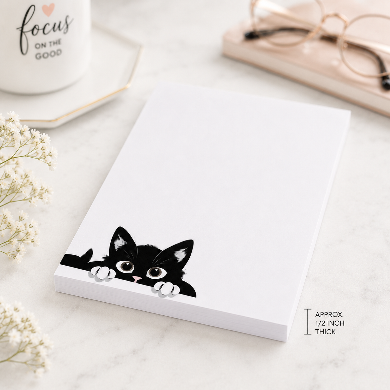 White notepad featuring a cute black kitten peeking from the bottom corner with plenty of blank writing space for notes, lists, and reminders.