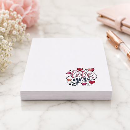 White tear-off notepad featuring a colorful "Love You" heart design in the lower corner, perfect for romantic notes, lists, and everyday stationery.