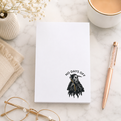 White notepad featuring a small grim reaper illustration and the words "No Days Off" in a minimalist dark humor design for notes, lists, and reminders.