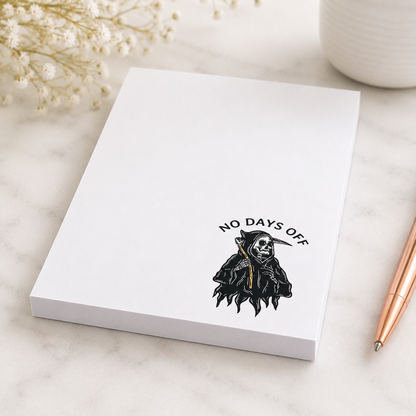 White notepad featuring a small grim reaper illustration and the words "No Days Off" in a minimalist dark humor design for notes, lists, and reminders.
