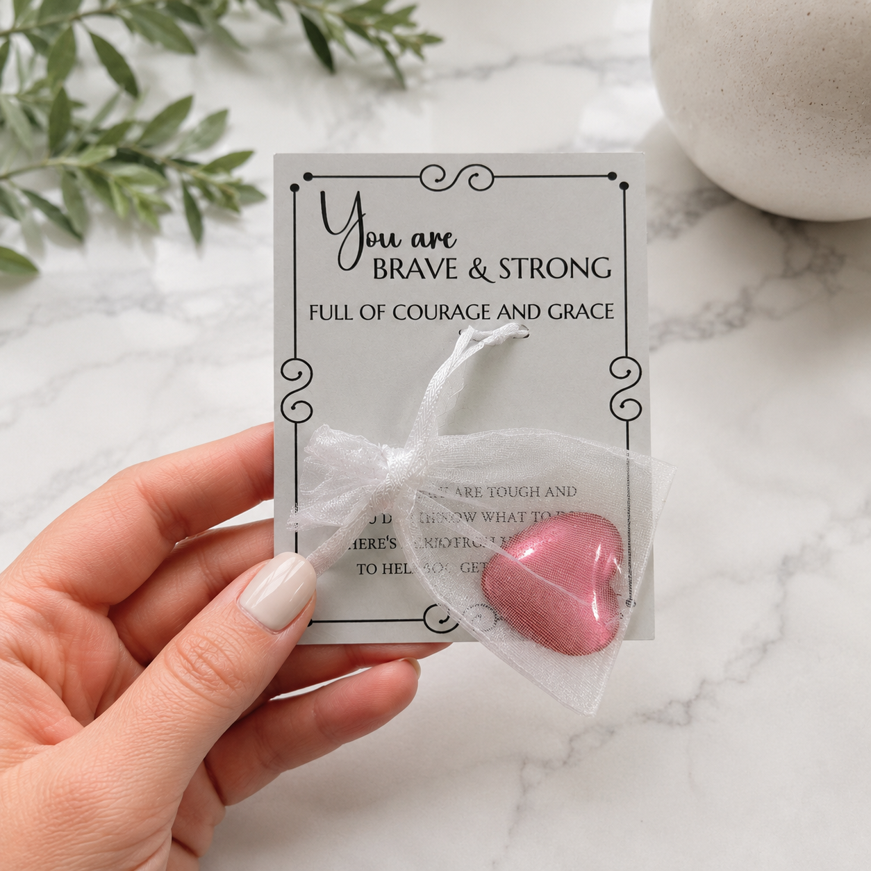 Inspirational pocket hug keepsake with a heart-shaped token on a "You Are Brave & Strong" encouragement card, a thoughtful comfort gift for friends, family, coworkers, or anyone needing support. Package in a small organza bag and comes with a cellophane sleeve