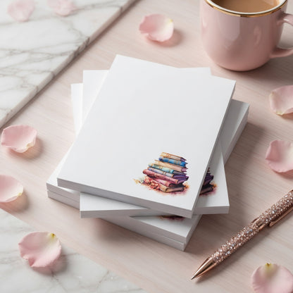 Book lover notepad featuring a watercolor stack of pastel vintage books in the corner with a clean writing area for notes, lists, and reminders.